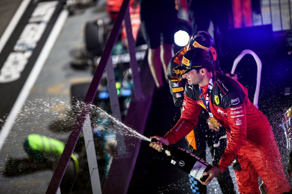 Carlos Sainz sprays his champagne in celebration after winning the 2023 Singapore Grand Prix. 