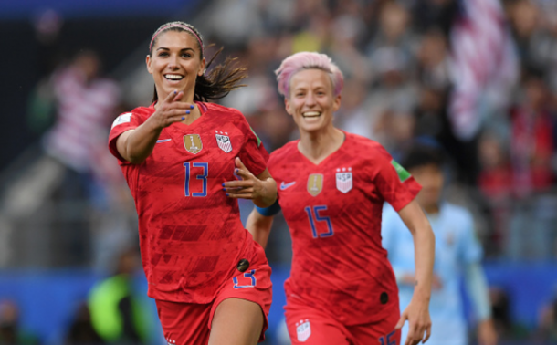 Alex Morgan (13) and Megan Rapinoe (15) celebrate one of their 13 goals against Thailand. (Photo by Alex Caparros - FIFA/FIFA via Getty Images)