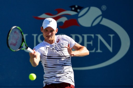 David Goffin hits a forehand return to Jared Donaldson during their first round match at the U.S. Open/Photo: Alex Goodlett/Getty Images