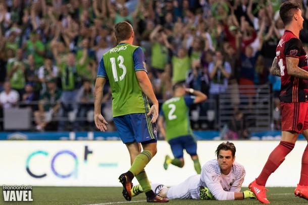 Clint Dempsey (background) celebrates after scoring his second goal against the Portland Timbers as Jordan Morris (13) watches and Portland goalkeeper Jake Gleeson (ground) stares off in disbelief | Souce: Brandon Farris - VAVEL USA