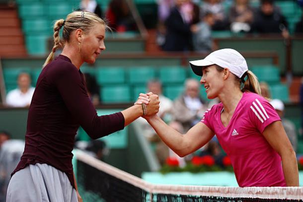 Maria Sharapova and Justine Henin meet after the Belgian's victory in the third round of the 2010 French Open (Getty/Clive Brunskill)