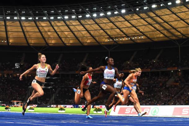 Asher-Smith crosses the line to capture her first International title at 100m (Getty/Matthias Hangst)