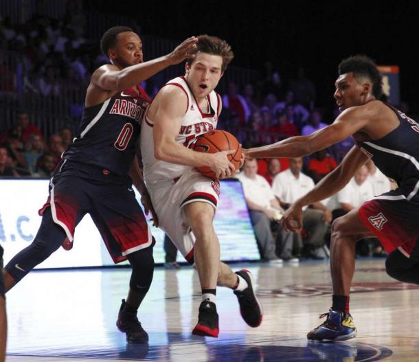 Beverly drives between two Arizona defenders/Photo: Tim Aylen/Associated Press