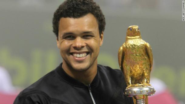 Jo-Wilfried Tsonga poses with the 2012 Qatar ExxonMobil Open trophy in Doha/Getty Images