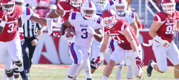 The Louisiana Tech Bulldogs run the ball against the Arkansas Razorbacks at Razorback Stadium in Fayetville/Getty Images