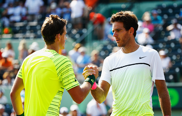 Vasek Pospisil of Canada meets Juan Martin Del Potro of Argentina at the net after defeating him during day 4 of the Miami Open