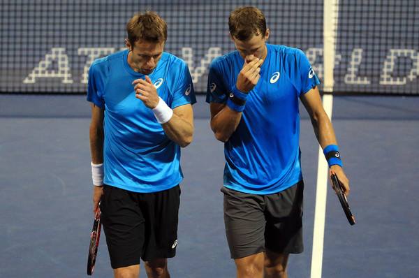 Daniel Nestor and Vasek Pospisil of Canada talk during a match against Tomas Berdych and Radek Stepanek of Czech Republic at the Rogers Cup 2016