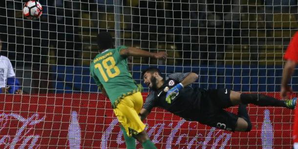 Simon Dawkins drills a shot in Jamaica's 2-1 win over Chile. | Photo: Andres Pina/Photosport