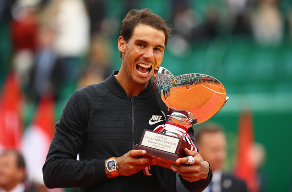 Rafael Nadal bites the trophy after winning his record-breaking 10th title in Monte Carlo last year. Photo: Clive Brunskill/Getty Images