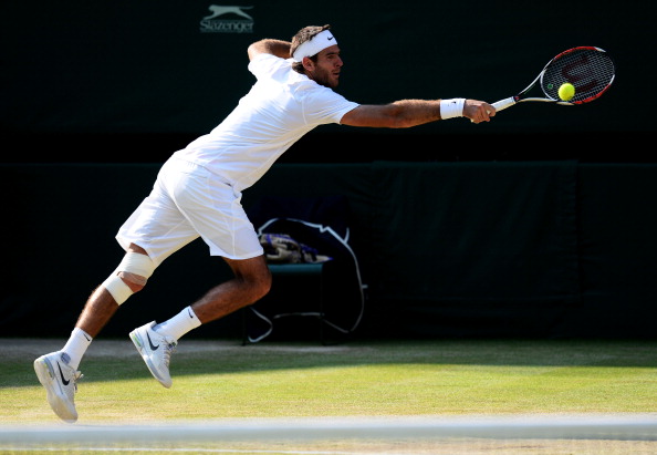 Juan Martin del Potro hits a backhand at Wimbledon 2013/Getty Images