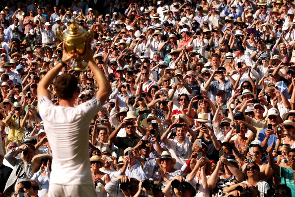 Fans cheer and take photographs as Andy Murray poses with the Gentlemen's Singles Trophy following his victory at Wimbledon 2013. (Photo by Clive Brunskill/Getty Images)