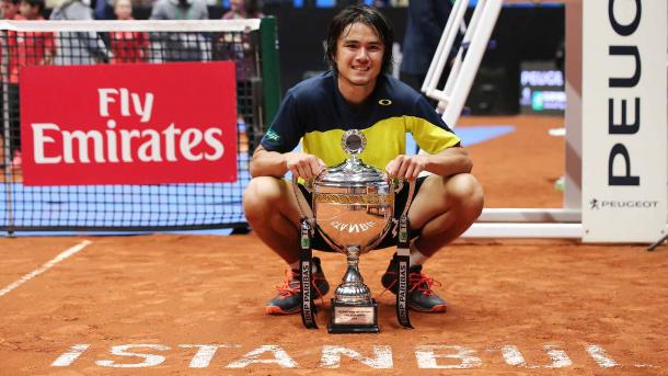 Taro Daniel poses with the first trophy of his career after winning in Istanbul. Photo: Koza World of Sports/ATP World Tour