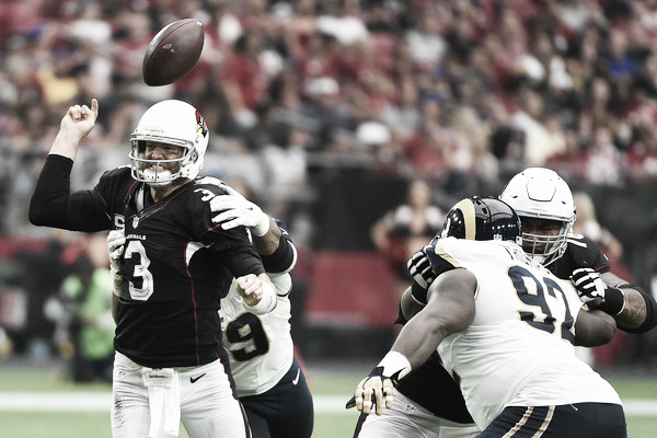 Quarterback Carson Palmer is hit by defensive tackle Aaron Donald (Oct. 1, 2016 - Source: Norm Hall/Getty Images North America)