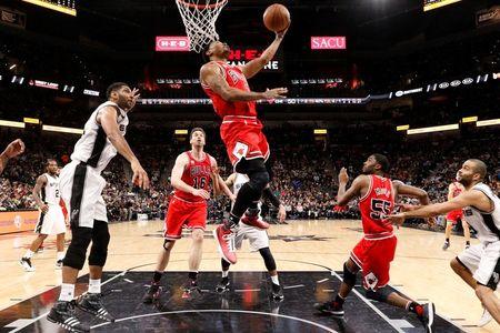 Chicago Bulls point guard Derrick Rose (1) gets past San Antonio Spurs power forward Tim Duncan (21, left) during the second half at AT&T Center. (Credit: Soobum Im-USA TODAY Sports)