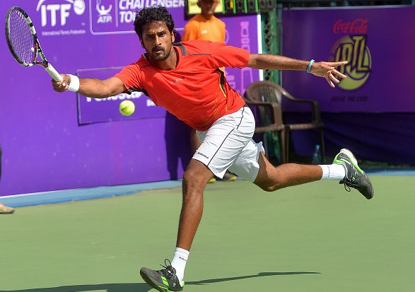 Saketh Myneni in action against Stephane Roberts at the Delhi Open 2016 at Delhi Lawn Tennis Association in New Delhi.(Photo by K Asif/India Today Group/Getty Images)