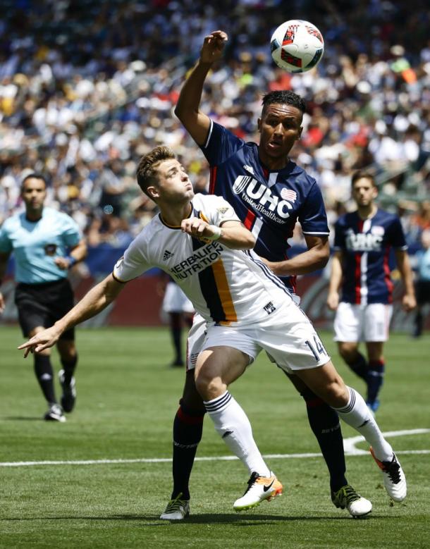 LA's Robbie Rogers (Center) attempting to block off New England's Juan Agudelo (Back) from the ball on Sunday at the StubHub Center. Photo provided by Chris Carlson-AP Photo. 