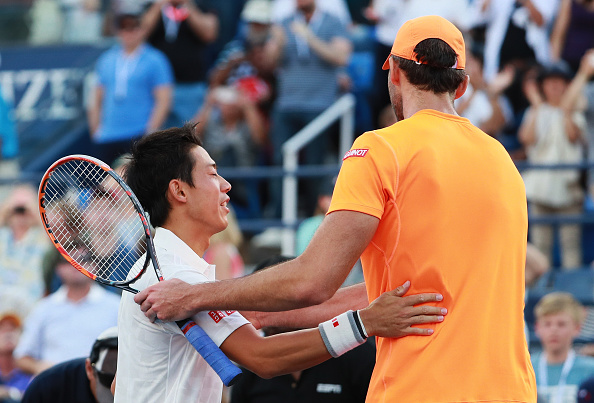 Kei Nishikori shakes hands with Ivo Karlovic following his victory (Photo: Michael Reaves/Getty Images)