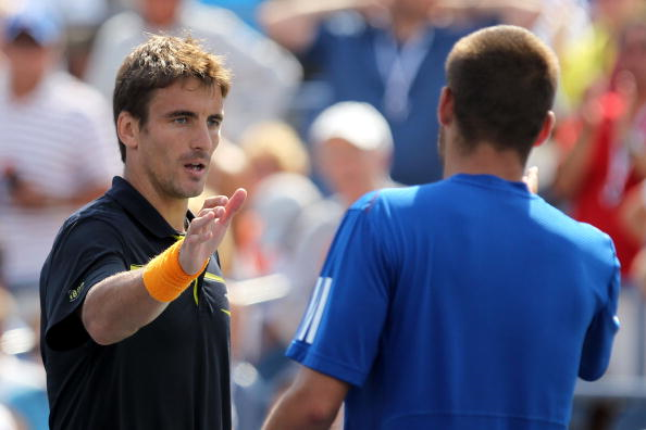 Tommy Robredo and Mikhail Youzhny, who are to make their returns shake hands after their 2010 US Open match (Photo: Al Bello/Getty Images)