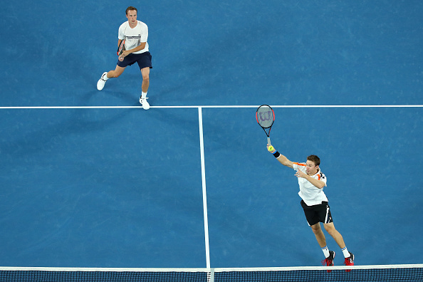 John Peers plays a smash to the watchful eye of Henri Kontinen (Photo: Cameron Spence/Getty Images)