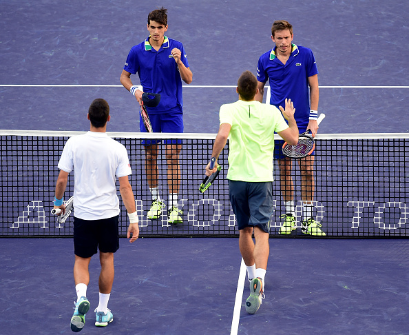 Pierre-Hugues and Nicolas Mahut congratulate Novak Djokovic and Viktor Troicki on their victroy (Photo: Harry How/Getty Images)