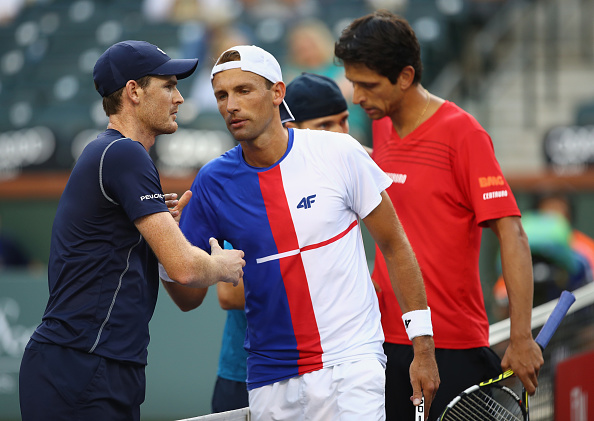 Jamie Mrray and Bruno Soares congratulate Lukasz Kubot and Marcelo Melo at the net (Photo: Clive Brunskill/Getty Images)