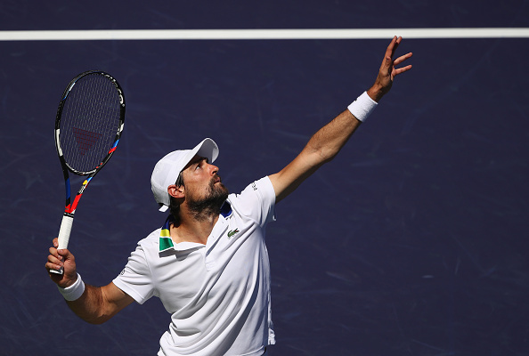 Jeremy Chardy hits a serve (Photo: Clive Brunskill/Getty Images)