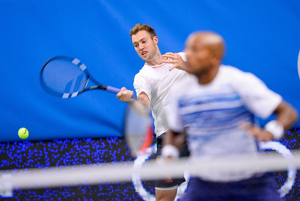 Jack Sock hits a forehand return with partner Nicholas Monroe on looking (Photo: Jonathan Nackstrand/Getty Images)