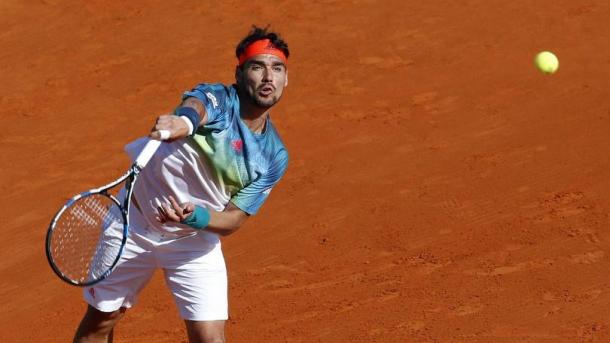 Fabio Fognini hits a serve on the clay of Monte Carlo during his first round match. (Photo: EPA)