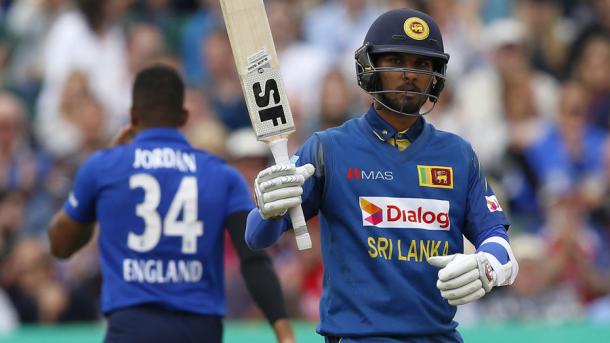 Chandimal holds up his bat during his innings of 62 | Photo: AFP