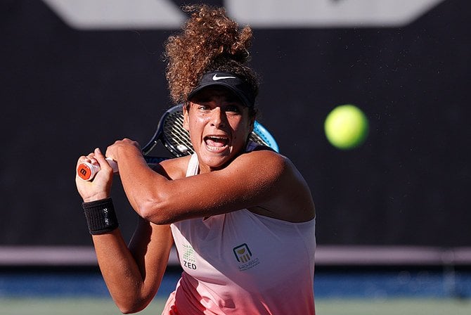 Firing off a backhand, the 24-year old looks to create more history in Melbourne/Photo: Jorge Ferrari/Tennis Australia