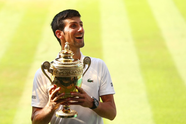 Novak Djokovic holds the trophy after winning his fourth Wimbledon. Photo: Matthew Stockman/Getty Images
