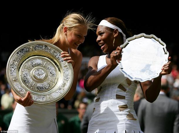 Maria Sharapova and Serena Williams have a chat while posing with their respective trophies after the 2004 Wimbledon final. Since then, Serena has gone 18-1 against Sharapova, with her only loss to the Russian coming at the year-end championships of that same year. | Photo courtesy of Getty Images