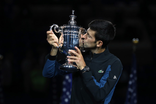 Novak Djokovic kisses his third US Open trophy on Sunday. Photo: Matthew Stockman/Getty Images