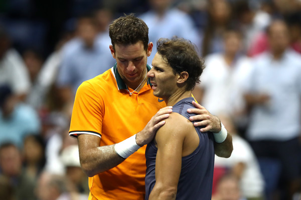 Rafael Nadal (right) is embraced by Juan Martin del Potro after the defending champion retired from their semifinal match. Photo: Julian Finney/Getty Images