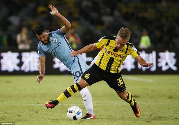 Above: Sergio Aguero battling with  Felix Passlack in Manchester City's 1-1 draw with Borussia Dortmund | Photo: Reuters