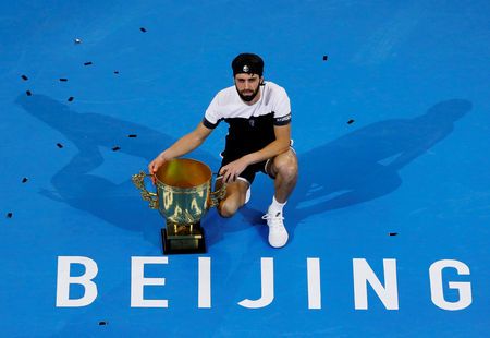 Nikoloz Basilashvili poses with his trophy after defeating Juan Martin del Potro. Photo: Thomas Peter/Reuters