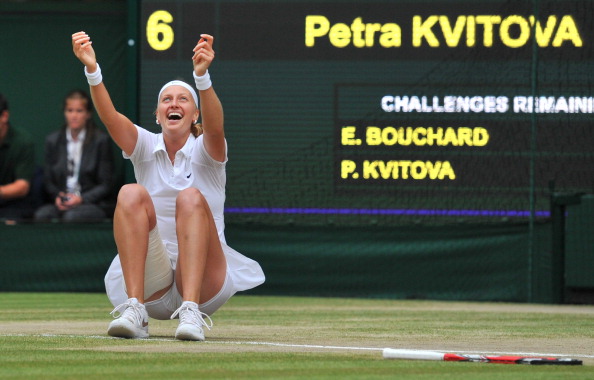 Kvitova collapses to the ground after converting her first championship point to win her second Wimbledon title in three years.. Photo credit: Glyn Kirk/Getty Images.
