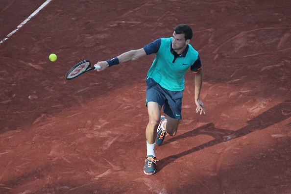 Grigor Dimitrov slides into a backhand at the 2015 TEB BNP Paribas Istanbul Open/Getty Images