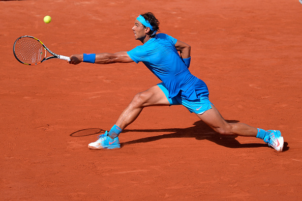 Rafael Nadal slides into a backhand at the 2015 French Open in Paris/Getty Images