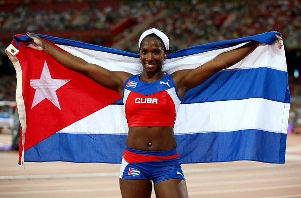 Yarisley Silva posing with the Cuban flag after winning the World Championships. Photo:Getty Images/Alexander Hessenstein