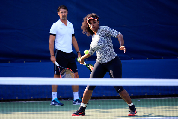 Serena Williams, hits a ball during a practice session as her coach Patrick Mouratoglou looks on prior to the U.S. Open. (Photo by Chris Trotman/Getty Images for the USTA)