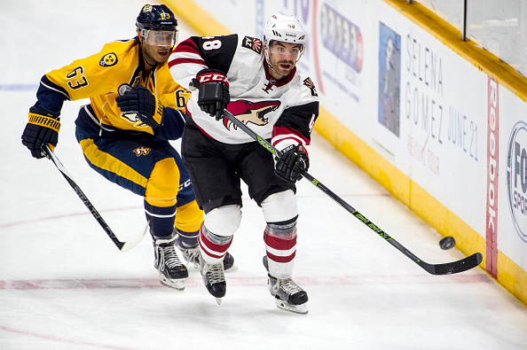 Jordan Martinook #48 of the Arizona Coyotes skates with the puck against Mike Ribeiro #63 of the Nashville Predators during a NHL game at Bridgestone Arena on December 1, 2015 in Nashville, Tennessee. (Photo by Ronald C. Modra/NHL/Getty Images)