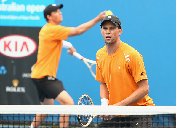 Bob Bryan (background) serves as brother Mike waits for the ball to go into play (Photo: Getty Images)