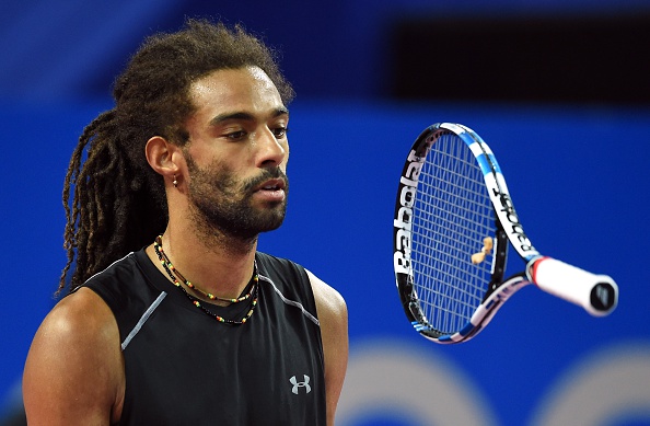 Dustin Brown flips his racquet up as the match turns against him (Photo: Getty Images)