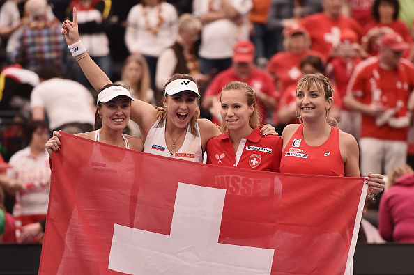 Golubic (second from right) and her teammates acknowledge their Swiss supporters after defeating hosts Germany in the opening round. Photo credit: Dennis Grombkowski/Getty Images.