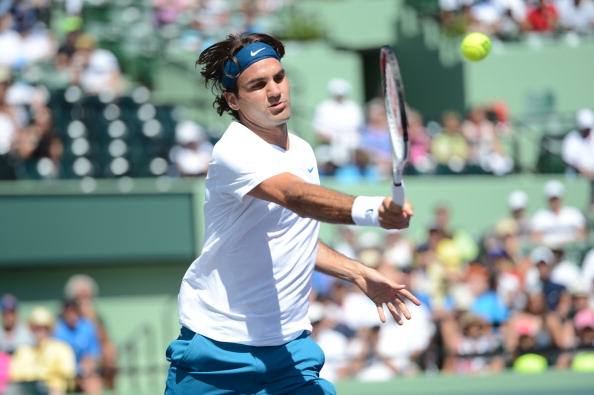 Roger Federer of Switzerland returns a shot to Ryan Harrison 