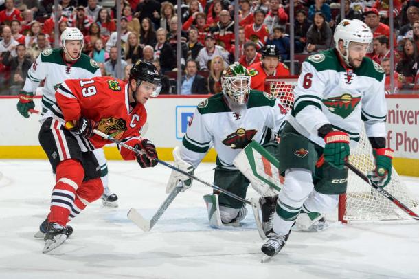 Jonathon Toews #19 and Marco Scandella #6 watch for the puck. Source: Bill Smith- NHLI via Getty Images