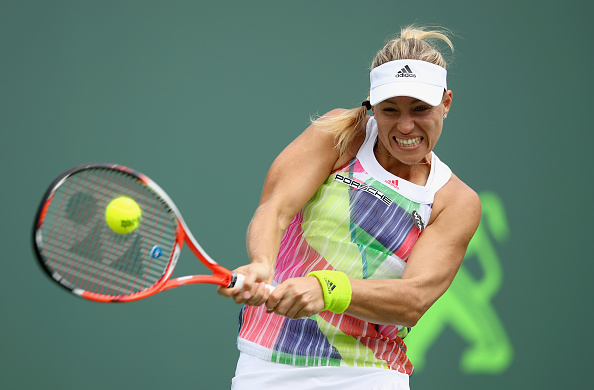 Angelique Kerber of Germany plays a backhand against Barbora Strycova of the Czech Republic in their second round match during the Miami Open. | Photo by Clive Brunskill/Getty Images