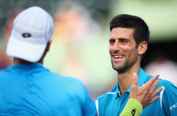 Novak Djokovic and João Sousa shaking hands at the net. As we can see both players get along very well. They practiced together in Monte-Carlo, Monaco in 2014 preparing the 2015 season.  (Photo by Clive Brunskill/Getty Images)