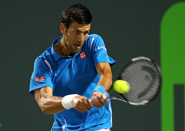 Novak Djokovic hits a backhand during his quarterfinal win over Tomas Berdych at the Miami Open/Getty Images